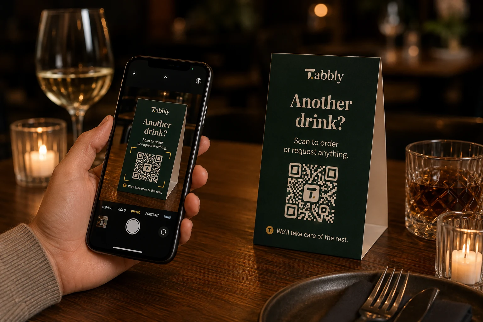 Guest scanning a Tabbly QR code table tent with a smartphone
